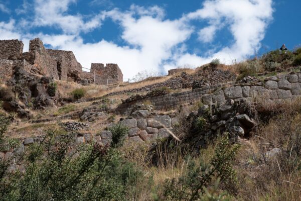 a stone wall on a hill with a sky background