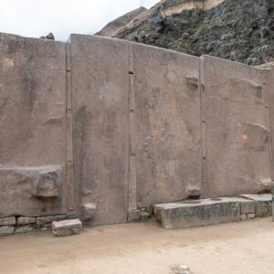 a large stone wall in the middle of a desert