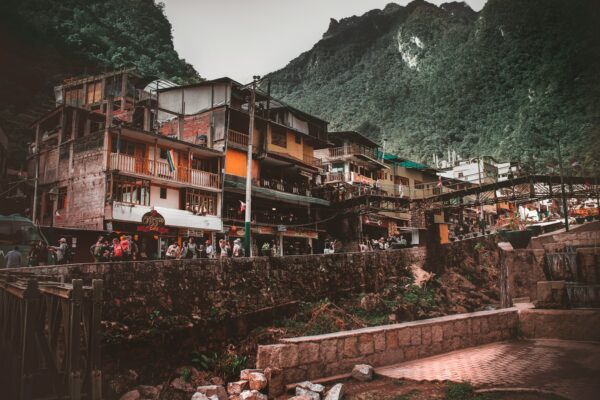 multicolored painted city buildings near green mountain